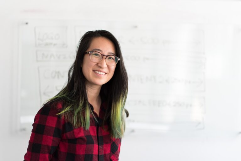 Photo of a woman in front of the whiteboard